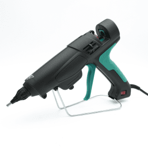 Hot melt glue gun standing on a detachable base stand